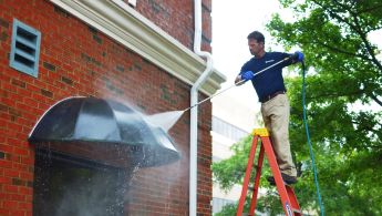 Man providing commercial pressure washing services